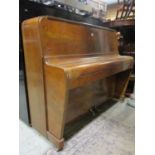 A small art deco walnut cased piano by Lestel with over strung iron frame action