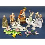 A collection of four Nao figures groups comprising a little girl playing with a puppy, a little