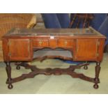 An antique walnut stand fitted with an arrangement of drawers and cupboards, under shelf, turned