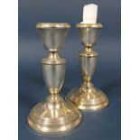Pair of silver baluster candlesticks upon stepped circular bases, 15 cm high