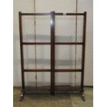 An Edwardian mahogany freestanding and folding clothes rail raised on swept supports