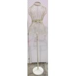 A contemporary cream painted light steel mannequin, female torso, raised on a tubular stand with