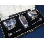 1940s cased three piece silver cruet in the Art Deco comprising salt, pepper, lidded mustard and two
