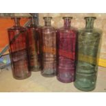 Five large contemporary moulded coloured glass cylindrical bottle shaped jars with drawn necks, 72