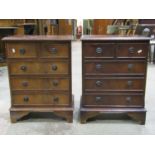 A pair of small reproduction Georgian style mahogany veneered chests of two short over three long