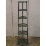 A Victorian style green painted cast alloy floorstanding saucepan stand set on six circular