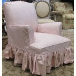 A vintage upholstered bedroom/drawing room chair with shaped outline, swept arms and loose sprig