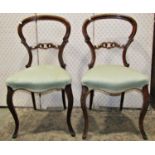 A pair of Victorian mahogany balloonback dining/occasional chairs with moulded frames, pierced and