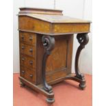 A Victorian walnut and figured walnut Davenport of usual form, enclosing four real and four dummy