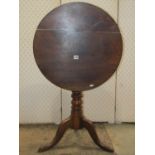 A 19th century mixed wood snap top occasional table of circular form raised on a ring turned