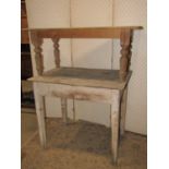 An antique painted pine kitchen side table, with rectangular overhanging boarded top, over a central