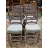 A harlequin set of twelve Lancashire style wavy ladderback dining chairs with rush seats, raised