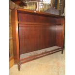 A reproduction mahogany freestanding open bookcase with moulded outline and two adjustable