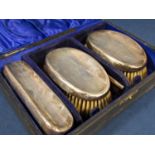 Cased silver topped dressing set comprising three brushes and a silver topped comb