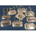 Set of six silver decanter labels of rectangular form with canted corners for Brandy, Gin,