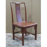 A Chinese hardwood side chair with solid seat, the simple splat back with carved detail together