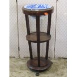 A 19th century mahogany washstand on three circular tiers, the upper with cut out bowl receptacle