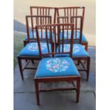 A matched set of five Georgian countrymade stick back dining chairs, in mixed woods including