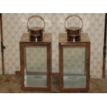 A pair of contemporary copperised lanterns of square cut form with glazed panels, single door and