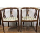 A pair of inlaid Edwardian mahogany tub chairs with carved and pierced splats and upholstered seats,