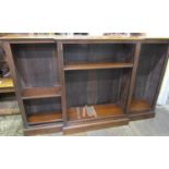 An Edwardian mahogany breakfront bookcase of half height, enclosing a series of adjustable