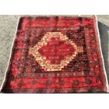 Good quality Senneh square rug with intricate medallion decoration upon a red ground, 115 x 115cm