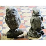 Two reclaimed garden ornaments in the form of owls perched on a branch, 34 cm and 32 cm in height