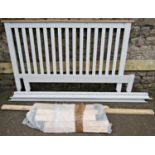 A contemporary double bedstead with painted finish and open vertical slatted headboard, (complete