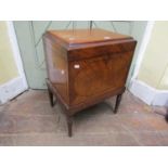A William IV mahogany wine cooler of rectangular form, with simple inlaid detail, raised on turned