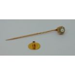 Antique yellow metal stick pin with pearl and diamond terminal and an 18ct dress stud, the