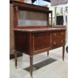 An early 20th century oak side cabinet, floorstanding and enclosed by a pair of partially glazed and