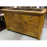 A good quality bespoke oak freestanding kitchen island enclosed by an arrangement of cupboards and