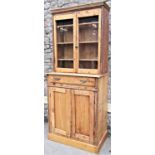 An old rustic reclaimed stripped pine kitchen dresser, the base enclosed by a pair of rectangular