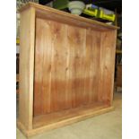 A stripped oak floorstanding oak bookcase with moulded skirting (lacks shelves) 161cm wide x 34cm