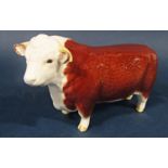 A Beswick model of a Hereford bull with circular printed mark to base, 19cm long approx