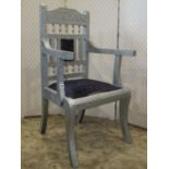 A floral and chevron banded sheet tin clad open elbow chair with upholstered seat and sabre