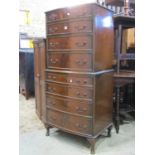 A small reproduction Georgian style bow front chest on chest of eight long graduated drawers