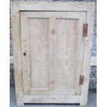 A Georgian stripped pine freestanding barrel back corner cupboard, enclosed by a rectangular moulded