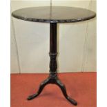 A 19th century mahogany occasional table, the circular top with carved border, raised on a carved