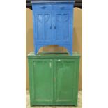 A vintage green painted pine framed freestanding side cupboard enclosed by a pair of rectangular ply