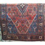 Unusual Persian Joshagan rug with central dark medallion framed by various still lives with