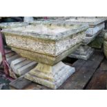 A pair of reclaimed garden planters of square cut and tapered form, with repeating rose detail,