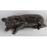 A David Selby bronze style resin slumped out pig, signed Selby, indistinctly dated 19?9, 42 cm