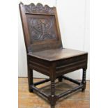 An 18th century oak side chair, the back with carved and decorated finish beneath a shaped
