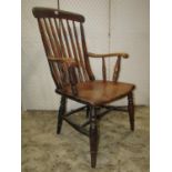 A Windsor stained elm and beechwood turned spindle/Roman candle back elbow chair with saddle