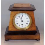Regency walnut and ebonised tapered sarcophagus mantel clock, the enamelled dial with Roman numerals