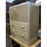 A stripped oak linen cupboard with fixed moulded handles enclosed by a pair of doors over two long