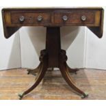 An unusually small Regency mahogany sofa table, the top with cross banded borders, fitted with two