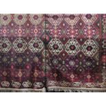 Large Kelim rug with geometric medallion decoration and highlights of vibrant pink upon a stone