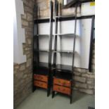 A pair of floorstanding wall supporting two sectional open shelving units, the ebonised frames